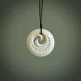 A hand carved and engraved koru pendant carved for us by Yuri Terenyi. These are beautiful little pieces are emblematic of the well known and loved Koru design.