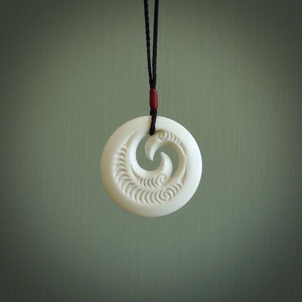 A hand carved and engraved koru pendant carved for us by Yuri Terenyi. These are beautiful little pieces are emblematic of the well known and loved Koru design.