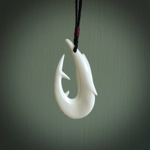 This is a beautiful bone carving pendant. We have designed a hook with a Kingfish motif especially for those lover of the ocean and all you fanatical fishermen out there. This piece is designed and made by NZ Pacific and is for sale worldwide.