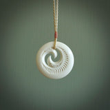 A hand carved and engraved koru pendant carved for us by Yuri Terenyi. These are beautiful little pieces are emblematic of the well known and loved Koru design.