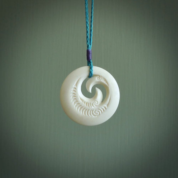 A hand carved and engraved koru pendant carved for us by Yuri Terenyi. These are beautiful little pieces are emblematic of the well known and loved Koru design.