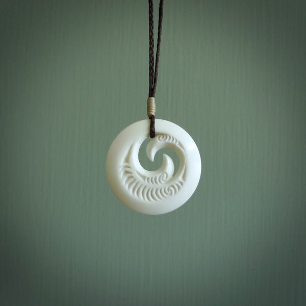 A hand carved and engraved koru pendant carved for us by Yuri Terenyi. These are beautiful little pieces are emblematic of the well known and loved Koru design.