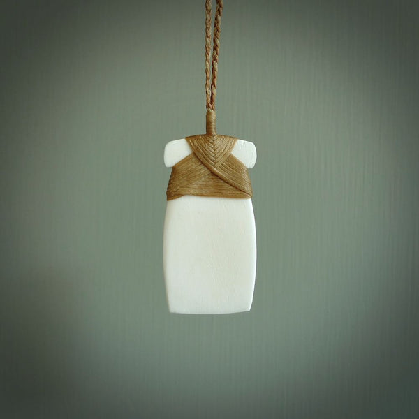 Hand carved Bone toki pendant. Made by NZ Pacific from natural bone with a traditional binding. Bone jewellery for sale online. South Pacific wearable art.