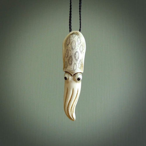 Hand carved squid pendant. This piece has been carved in minute detail from deer antler. The artist is Fumio Noguchi, a renowned New Zealand bone carver who carves pieces for NZ Pacific. These unique bone pendants are for sale online at nzpacific.com