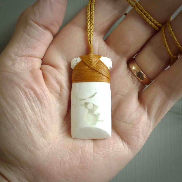 This pendant is a lovely toki carved from white onyx stone. It is a traditional shape and is traditionally bound but carved from a striking white stone. A beautiful piece of handmade jewellery from NZ Pacific.