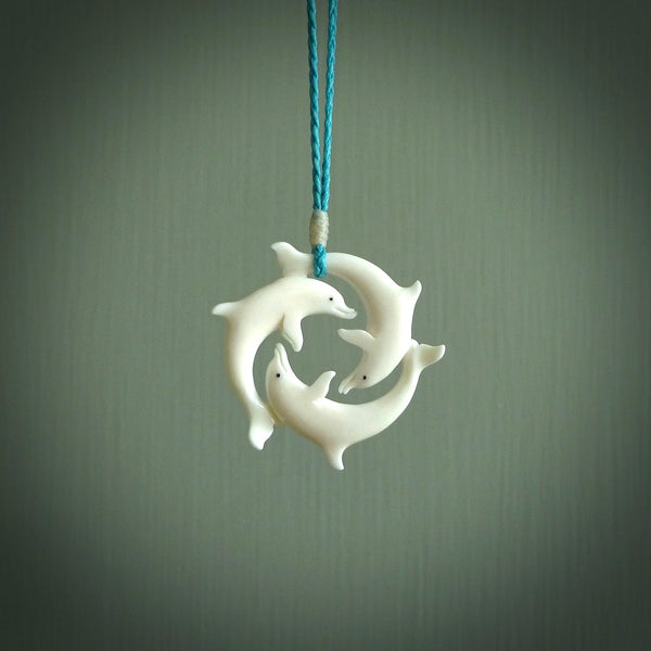 Hand carved dolphin trio. Made from natural bone by NZ Pacific.