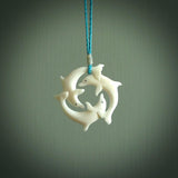 Hand carved dolphin trio. Made from natural bone by NZ Pacific.