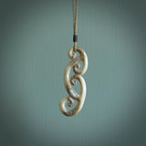 This is a wonderful, gently curved piece with a multiple koru design. We've carved this from deer antler and bind it on hand-plaited cords of various colours. Order yours now on NZ Pacific at www.nzpacific.com