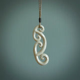 This is a wonderful, gently curved piece with a multiple koru design. We've carved this from deer antler and bind it on hand-plaited cords of various colours. Order yours now on NZ Pacific at www.nzpacific.com