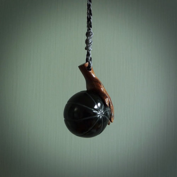 This is a very cool pendant that we've had carved for all you Basketball fans. The DUNK is a pendant with a woolly mammoth tusk hand holding a black jade basketball. We provide this on an adjustable black cord, and we ship worldwide. A very cool pendant, different, edgy and very wearable.