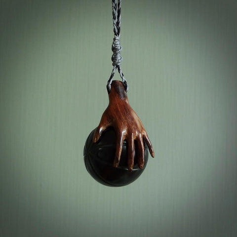This is a very cool pendant that we've had carved for all you Basketball fans. The DUNK is a pendant with a woolly mammoth tusk hand holding a black jade basketball. We provide this on an adjustable black cord, and we ship worldwide. A very cool pendant, different, edgy and very wearable.