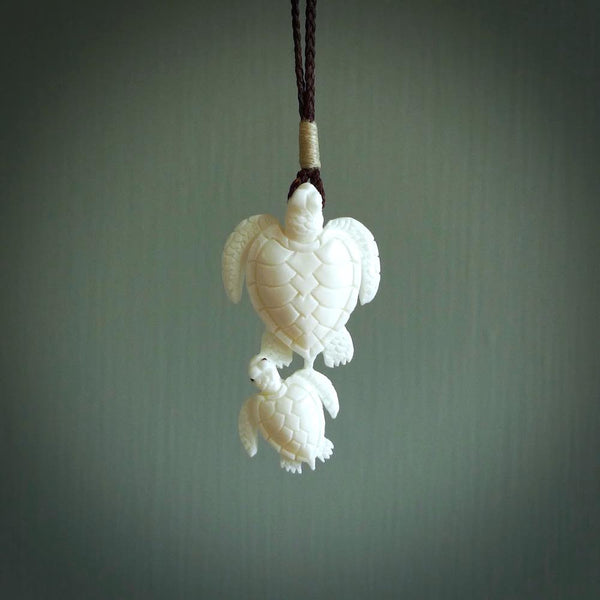 Pair of turtles hand carved in bone. Hand carved jewellery made by NZ Pacific and for sale online. Moana jewellery, handcarved in bone.