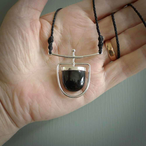 Hand crafted contemporary black jade and sterling silver drop necklace. This necklace is provided with a fern green cord and silver clasp. Contemporary black jade drop necklace with sterling silver.