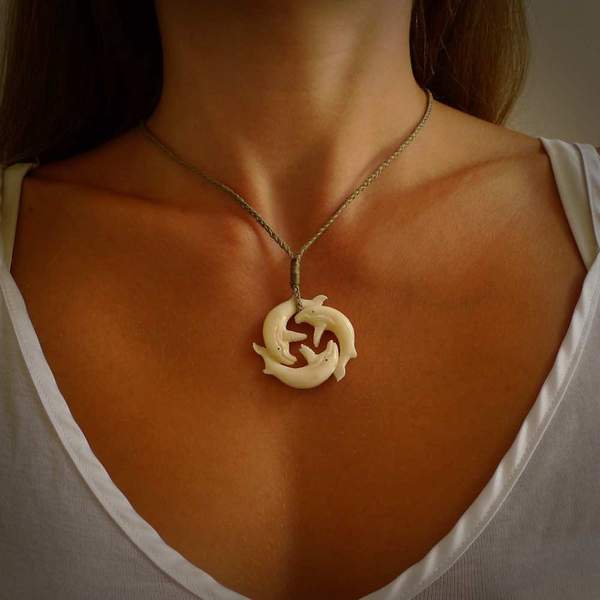 Hand carved natural bone whale trilogy pendant. Art to wear. Ocean themed pendants.