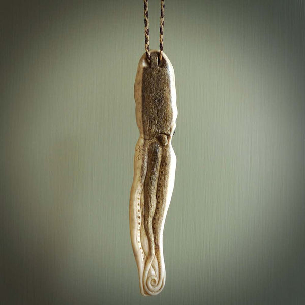Hand carved octopus pendant. This piece has been carved in minute detail from deer antler. The artist is Fumio Noguchi, a renowned New Zealand bone carver who carves pieces for NZ Pacific. These unique bone pendants are for sale online at nzpacific.com One only collectors item for lovers of the ocean and octopus.