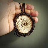 A hand carved double fern leaf pendant made from a piece of deer antler crown. This is a work of art carved by Fumio Noguchi who is renowned for his skill in bone carving. The moa is an extinct, flightless native New Zealand bird. This is a great piece representing this very rare bird.