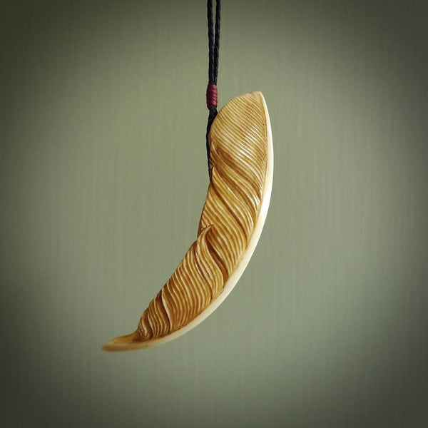 Hand made cow bone feather leaf necklace. Real boars tusk bone stained with homemade dye. Free worldwide delivery. Cool gifts from NZ Pacific. Feather pendant. Delivered with DHL Express Courier. 