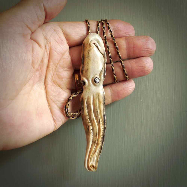 Hand carved octopus pendant. This piece has been carved in minute detail from deer antler. The artist is Fumio Noguchi, a renowned New Zealand bone carver who carves pieces for NZ Pacific. These unique bone pendants are for sale online at nzpacific.com One only collectors item for lovers of the ocean and octopus.