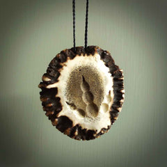 A hand carved double fern leaf pendant made from a piece of deer antler crown. This is a work of art carved by Fumio Noguchi who is renowned for his skill in bone carving. The moa is an extinct, flightless native New Zealand bird. This is a great piece representing this very rare bird.