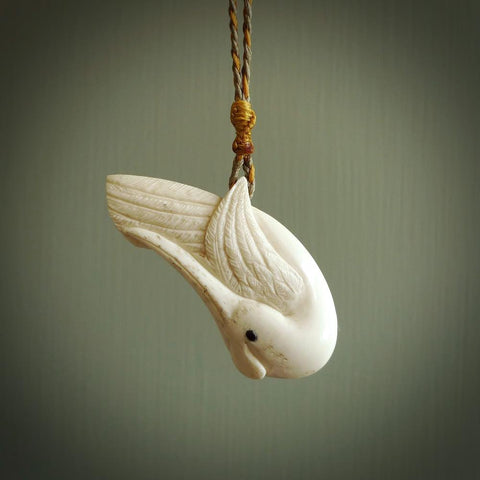 Hand carved huia bird made from cow&nbsp;bone pendant. Carved for NZ Pacific by Fumio Noguchi. This is a contemporary piece of jewellery that is carved with intricate detail and clearly shows a beautiful bird. We ship this free worldwide.