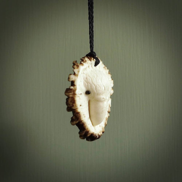 A hand carved Kakapo pendant made from a piece of deer antler crown. This is a work of art carved by Fumio Noguchi who is renowned for his skill in bone carving. The kakapo is a flightless parrot native to New Zealand and is at risk of becoming extinct. This is a great piece representing this very rare bird.
