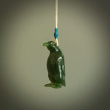 This pendant is a hand carved EMPEROR penguin. We've carved this from a lovely piece of green jade and we provide it with a hand plaited cord. Shipping is free worldwide.