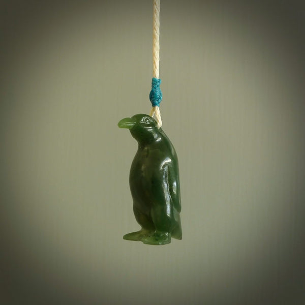 This pendant is a hand carved EMPEROR penguin. We've carved this from a lovely piece of green jade and we provide it with a hand plaited cord. Shipping is free worldwide.