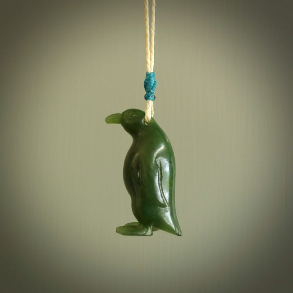 This pendant is a hand carved EMPEROR penguin. We've carved this from a lovely piece of green jade and we provide it with a hand plaited cord. Shipping is free worldwide.