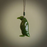 This pendant is a hand carved EMPEROR penguin. We've carved this from a lovely piece of green jade and we provide it with a hand plaited cord. Shipping is free worldwide.