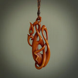 A one off beautiful piece of carved art. We have called this Enigma, it was hand carved for us by Yuri Terenyi and is a manaia with twist design pendant. This is a wonderful ethnic bone pendant designed to be worn. It has been stained by a homemade tea dye in a bright gingery brown colour and we have hand plaited an adjustable cord in khaki, ice white and ginger nut colours.